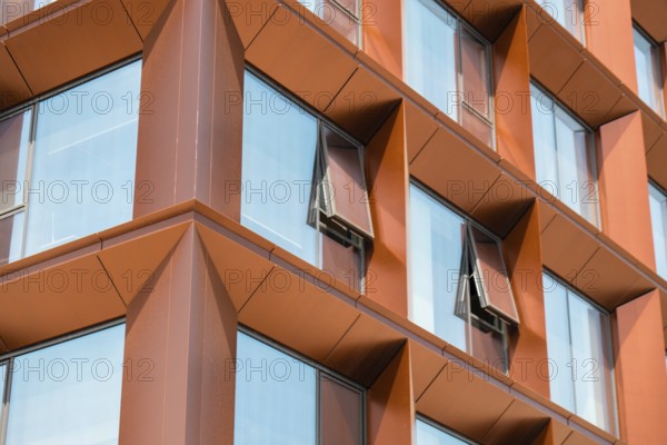 Modern office building exterior with glass facade on clear sky background. Transparent glass wall of office building with yellow decoration. Abstract Structure Element of facade of modern European building Commercial office buildings. modern business architecture Architecture minimal concept. Visual art. Conceptual photography