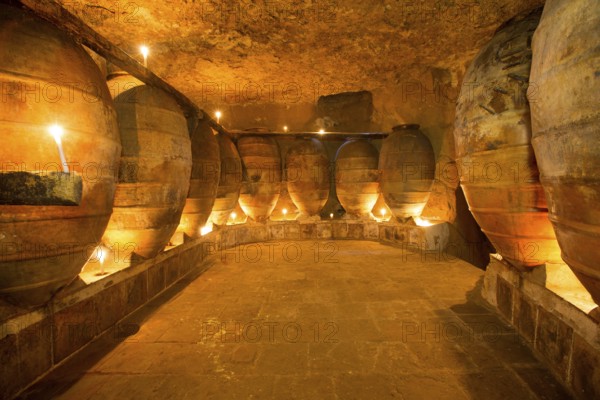 Antique winery in Spain with clay vessels terracotta amphora pots Mediterranean tradition with candlelight