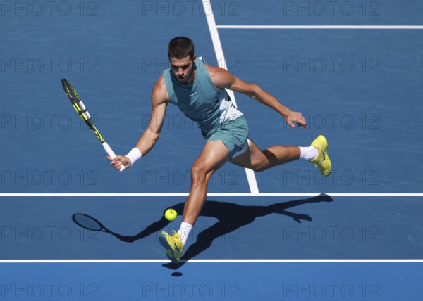 Spanish tennis player Carlos Alcaraz (ESP) playing forehand shot at Australian Open 2025 tournament, Melbourne Park, Melbourne, Victoria, Australia