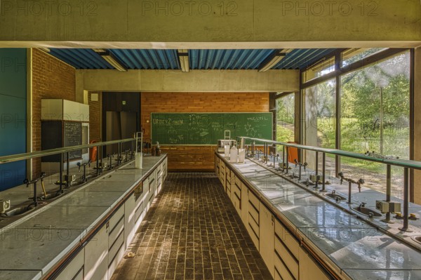 Empty classroom with view of green trees through windows, blackboard and laboratory tables, Institute of Molecular Biology, Lost Place, Sint-Genesius-Rode, Province of Flemish Brabant, Belgium