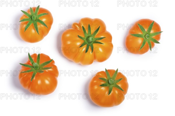 Yellow ribbed heirloom tomatoes (Solanum lycopersicum var. Togorific). Clipping paths, shadows separated, top view