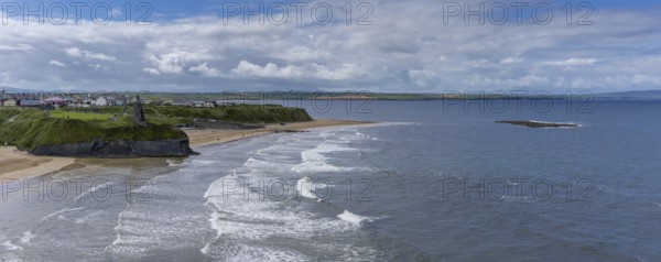 Ballybunion, Ireland, 5 August, 2022: panorama view of the Ballybunion Castle ruins on the clifftop and Ballybunion Beach in western Ireland