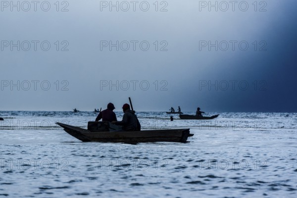 Tourists on a mooring enjoying the sunset, Lake Atitlan and San Pedro volcano, Santiago Atitlan, Sololá department, Guatemala, Central America