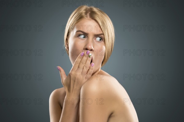 Portrait beautiful blond woman with blue eyes in azure background. Closeup