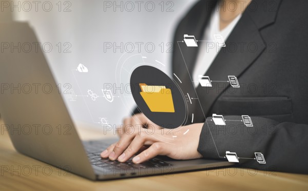 Document Management System (DMS), online documentation database and process automation to efficiently manage files, knowledge and documentation in enterprise with ERP. IT consultant working on laptop