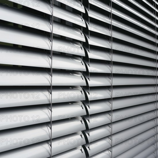 Venetian blind as sun protection on the window of a B