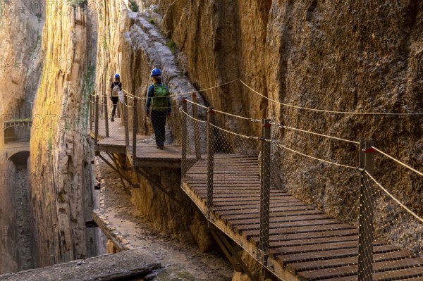 El Chorro, Spain - 22 February, 2022: tourists enjoy hiking the Camino del Rey on a bautiful winter day