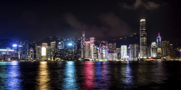 HONG KONG, CHINA - SEPTEMBER 27 2024: Night time view of Hong Kong Island and Victoria Harbour from Kowloon on a autumn evening, Hong Kong, China