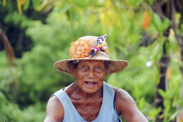 Portrait of a balinese old woman looking at camera