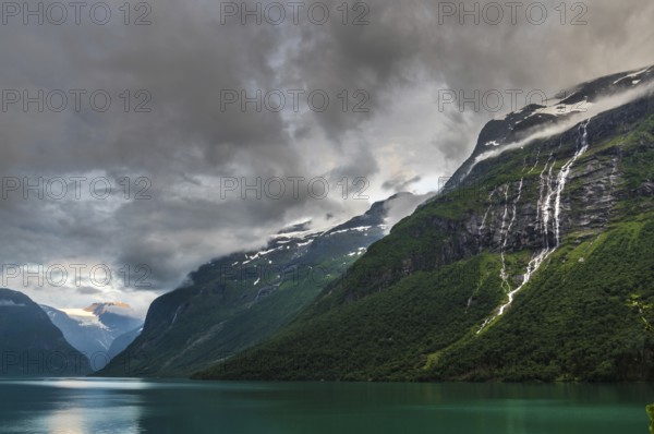 The Kjenndalsbreen is part of the Jostedalsbreen, one of the largest glaciers in Norway, and forms an impressive mountain landscape with a beautiful lake in Sande. The glacier Kjenndalsbreen with a lake in Norway is a beautiful place to travel to in summertime