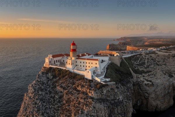 Portuguese coast with a lighthouse in the rays of the setting sun, Cabo De Sao Vincente on sunset