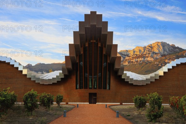 Fantastic beauty. The magnificent modern architecture of Bodegas Ysios. Bright flaming colors of the sunset. Journey to the warm Spanish autumn