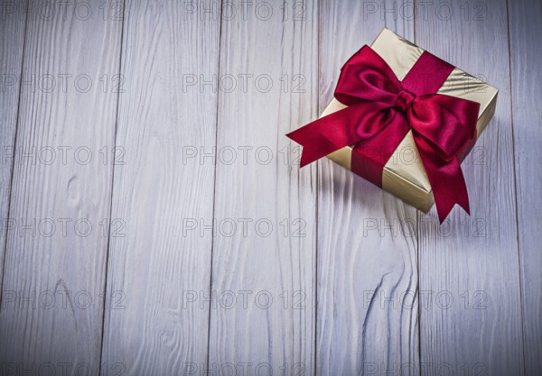 Wrapped giftbox on wooden board holidays concept