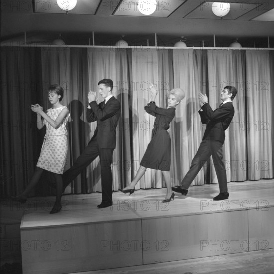 Dancing in the 1960s. The dance Hully Gully is being made popular and here are men and women dancing the new craze. Hully Gully was a type of unstructured line dance and consisted of a series of steps and was relatively simple and easy to execute. Hully Gully can be seen performed by actor John Belushi in the film Blues Brothers. Picture taken 1963