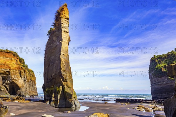 Amazing rock formations on Tongaporutu beach. Pacific coast. New Zealand. Narrow strip of sand along the shore has become exposed