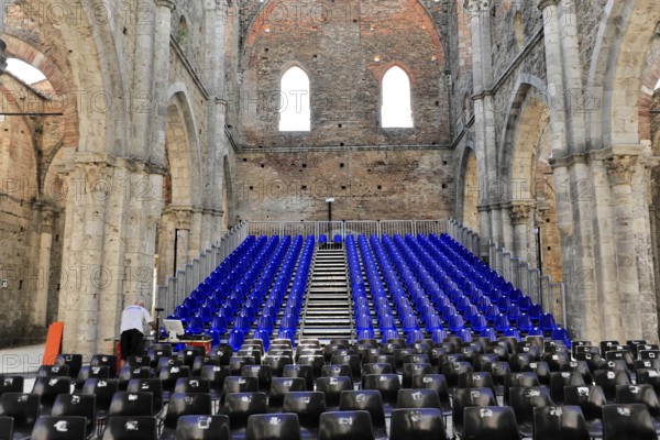 Church ruins of the Cistercian Abbey of San Galgano, Abbazia San Galgano, Gothic, Chiusdino, Tuscany, Italy, Europe, Interior view of an abandoned church with rows of seats and open stone walls and a small window