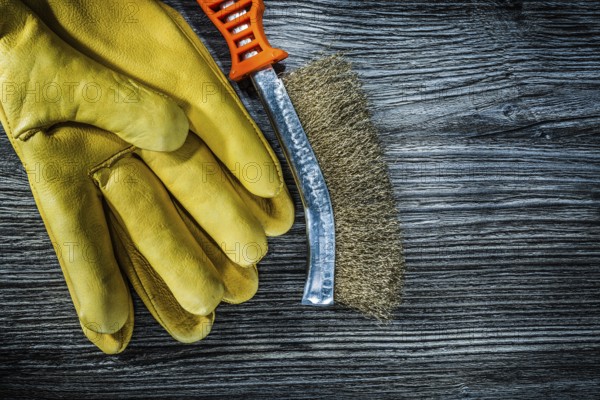 Wire brush safety gloves on vintage wooden board