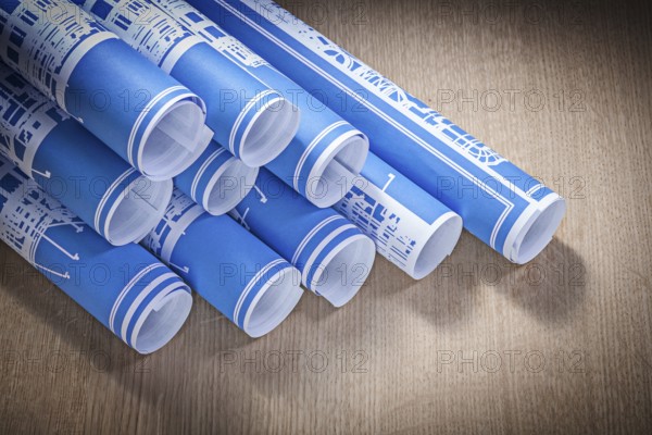 Blue engineering drawings on wooden board construction concept