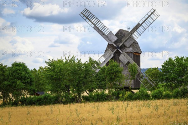 A view of a beautiful windmill in Thuringia Germany in a natural setting and an eye catcher for tourists