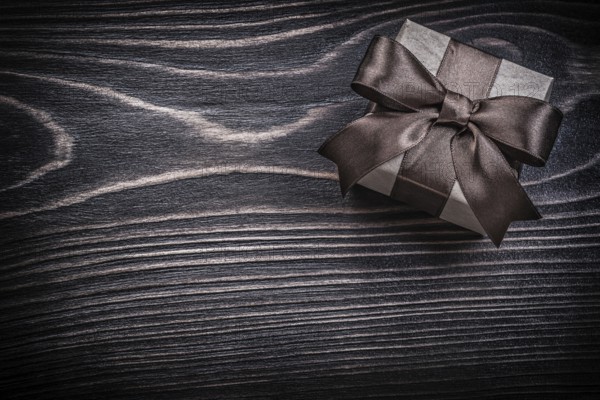 Present box on wooden board holidays concept