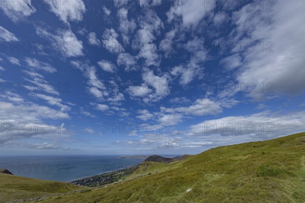 Vast rolling countryside with green meadows and sea views on the edge of Snowdonia National Park, Penmaenmawr, Dwygyfylchi, Caernarfonshire, Conwy County Borough, Wales, United Kingdom