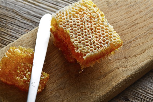 Honey honeycomb detail macro texture on wood