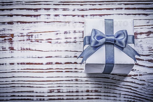 Present box on vintage wooden board holidays concept