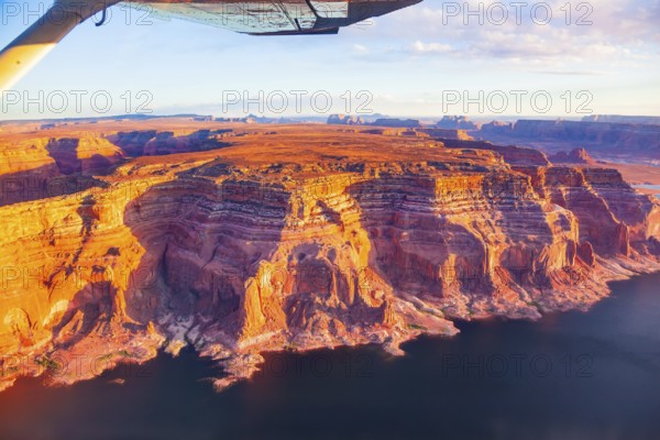 Photo from a bird's eye view. Lake Powell is a reservoir on the Colorado River. USA. States of Utah and Arizona. Huge lake of among the red sandstone cliffs