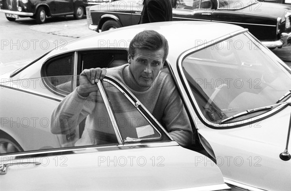 Sir Roger Moore, 1927-2017 during the filming of the tv-series The Saint, posing with a Volvo P1800. A sports car manufactured by Volvo Cars wtih production start 1961 and ending 1973. Styling was by swedish designer Pelle Pettersson. The car was indroduced at the Geneva Motor Show in 1961. The model P1800 sold 47492 cars.The P1800 became widely known when driven by then future James Bond actor Roger Moore as Simon Templar in the television series The Saint. The Saint ran from 1962 for six seasons and 118 episodes. 1966 Sir Roger Moore, 1927-2017 during the filming of the tv-series The Saint 1966. Roger Moore is known for his role as agent James Bond, playing the character in seven feature films