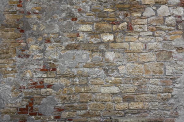 Rustic wall made of clay bricks brown and red