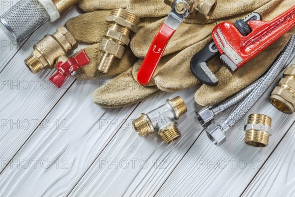 Plumbing tools pipe fixtures and walves pipewrench on wooden boards