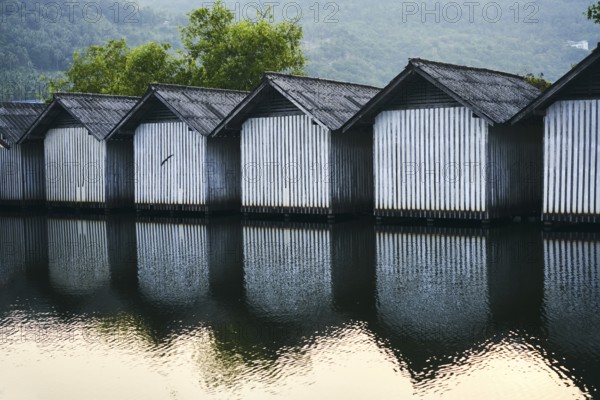 Row of houses on the river with reflections in the water