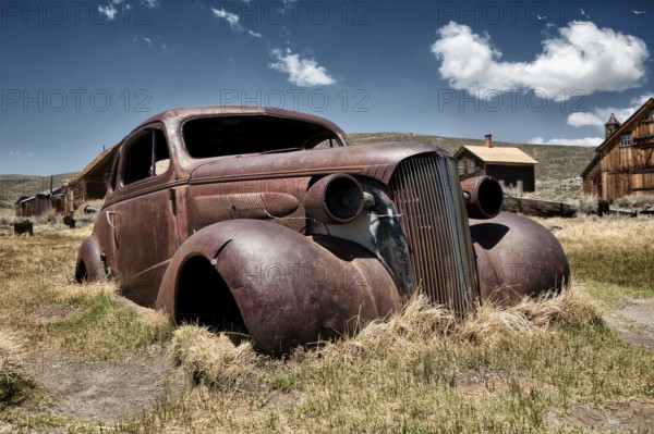 Rusty car wreck in the abandoned gold mining town of Bodie, USA