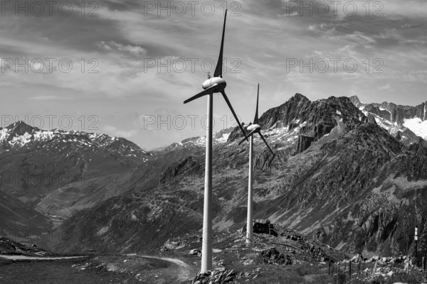 Wind Turbine and Mountain with Glacier and Against Sky and Clouds in a Sunny Summer Day in Andermatt, Uri, Switzerland
