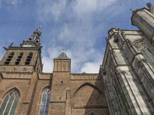 Gothic church tower and façade against a blue sky, nijmegen, the netherlands