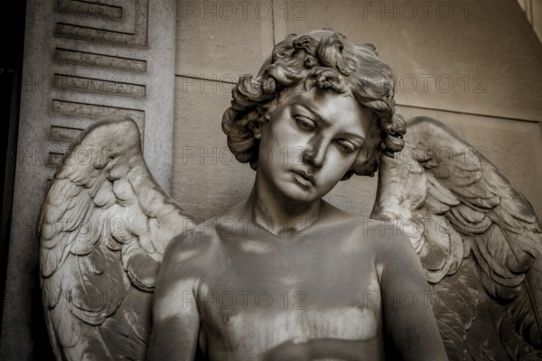 GENOA, ITALY, June 2020: antique statue of angel (beginning 1900, marble) in a Christian Catholic cemetery, Italy