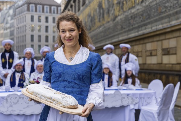 To mark the official start of the stollen season, the Dresden stollen girl Lorna Prenzel and the Dresden stollen bakers brought a large table to the Fürstenzug and thus a special place in the centre of Dresden's old town, Press event Stollen girls, Dresden, Saxony, Germany