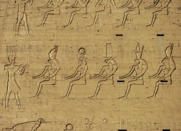 Hieroglyphic carvings on the exterior walls of an ancient egyptian temple
