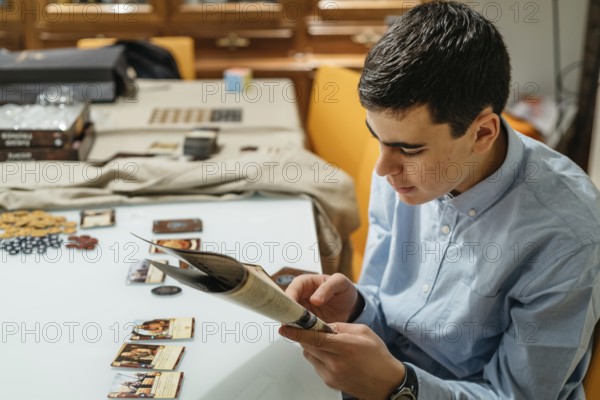 Boy reading boardgame rules playing at home