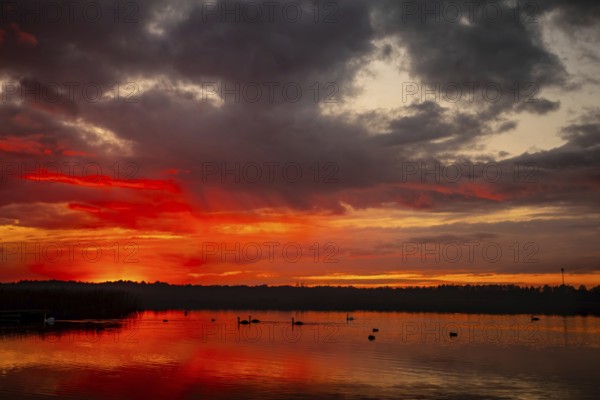 A breathtaking sunset captivatingly painting the sky with vibrant colors that shimmer over tranquil waters