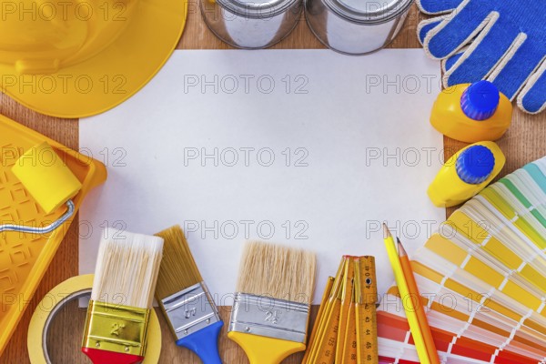 Collection of repair and paint tools on clean sheet of paper construction concept