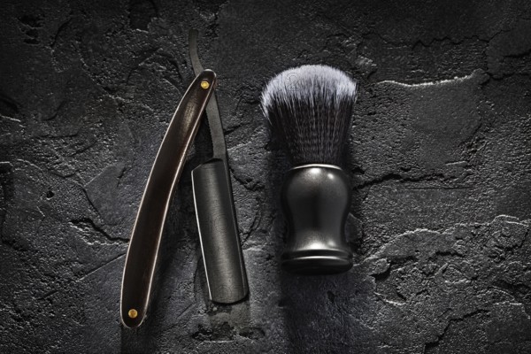 Black Barber Tools. Shaving Brush And Opened Straight Razor With Classic Wooden Handle On Abstract Dark Background