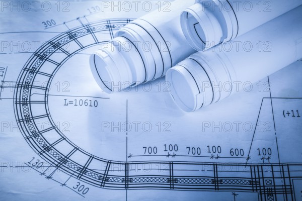 Rolled construction drawings on blueprint