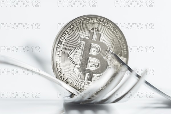 Macro photo of Bitcoin cryptocurreny fork concept with reflection, hard fork
