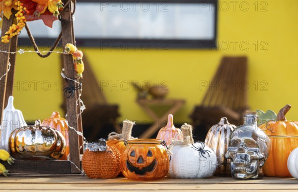 Autumn decor on the porch of the house outside in the yard of pumpkin, lantern, garlands, hats, jack lantern. Halloween party, autumn mood, Harvest festival