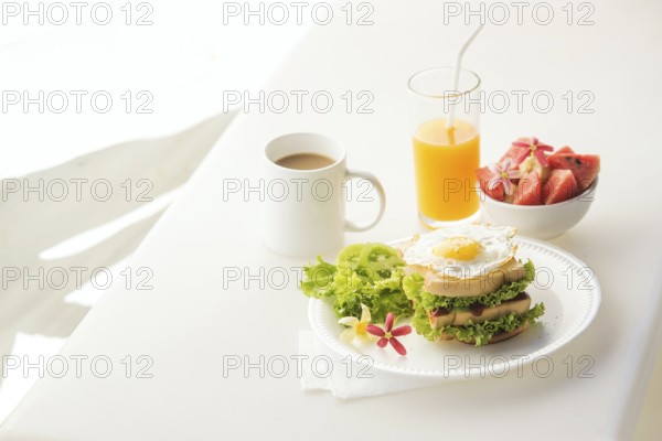 Egg and salad sandwich with fruit salad juice and coffee breakfast set