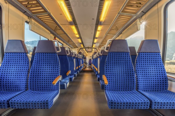 Image with the interior of a german border train. A modern train with comfortable and colorful chairs