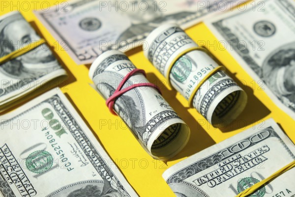 US dollars bundle close up isolated on dollar background. Paper denominations of dollars cash rolls with rubber bands. Business budget of wealth and prosperity finance. Pile capital of American US dollars bills notes cash