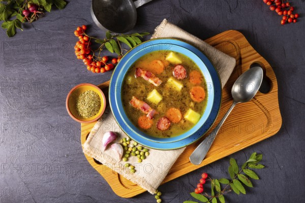 Polish pea soup (grochowka) with smoked bacon and sausage