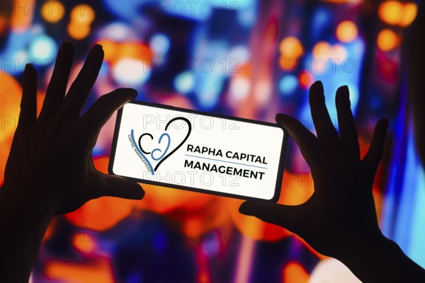 In this photo illustration, the Rapha Capital Management logo is displayed on a smartphone screen